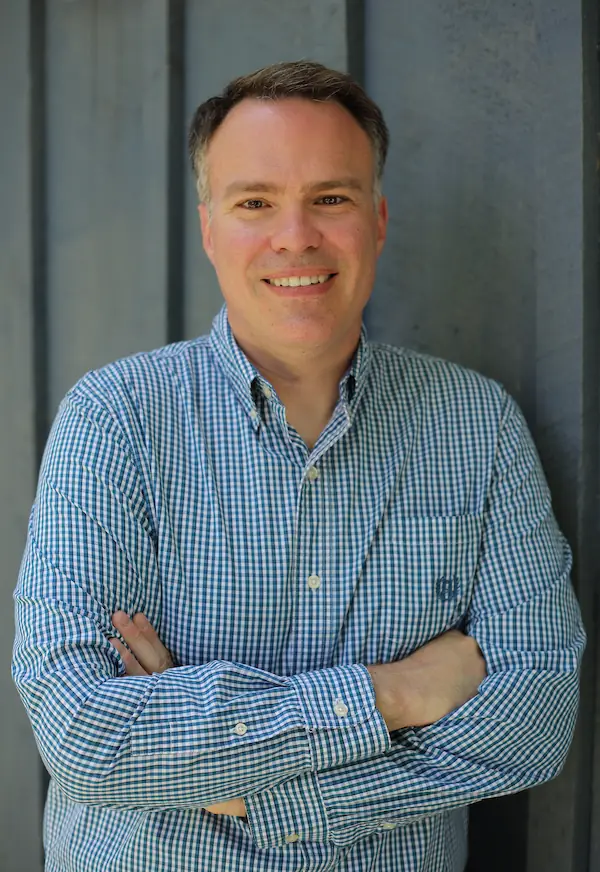 toronto wills lawyer blake chapman in blue shirt leaning against wall